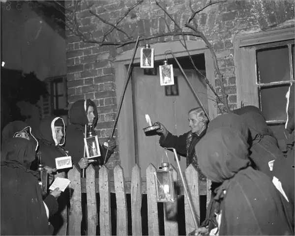 An Eynsford resident has a visit from hooded carol singers. 1935