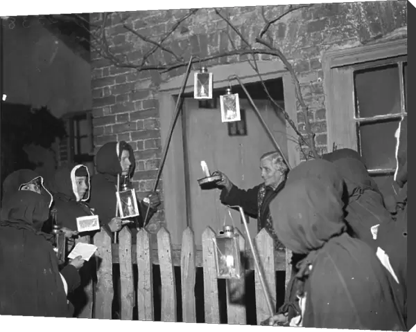 An Eynsford resident has a visit from hooded carol singers. 1935