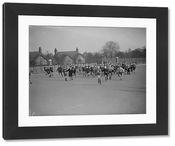 School children rush out onto the school playground at break time in Erith, Kent