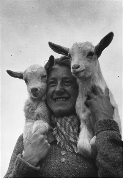 Connie Gurney holding a pair of kids at a goat farm in birling, Kent, 1939