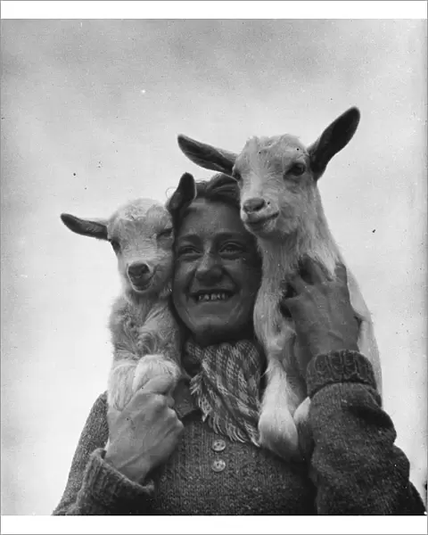 Connie Gurney holding a pair of kids at a goat farm in birling, Kent, 1939