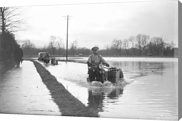 An a Patrolman risks the flooded road on his motorbike. 1936