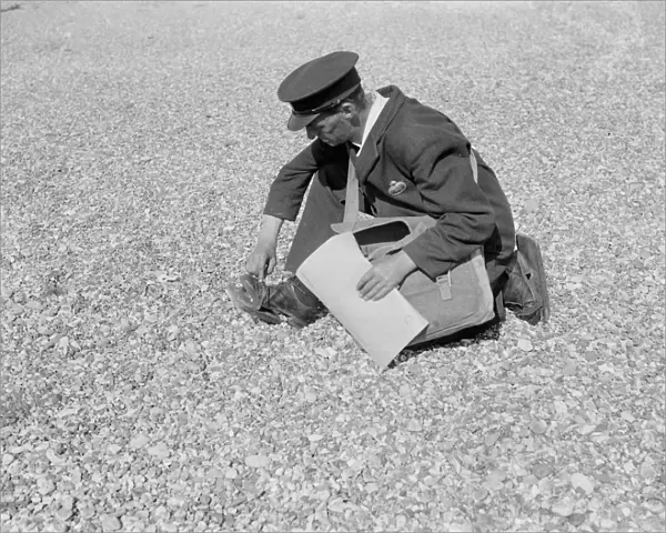 Mr Freathy, the postman at Dungeness, puts on wooden beach shoes to help him walk