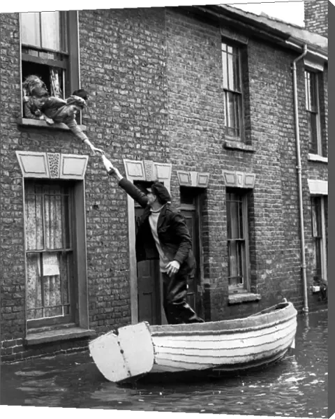Bill Washford in a boat outside his house in Clyde Street Sheerness Kent fetch supples