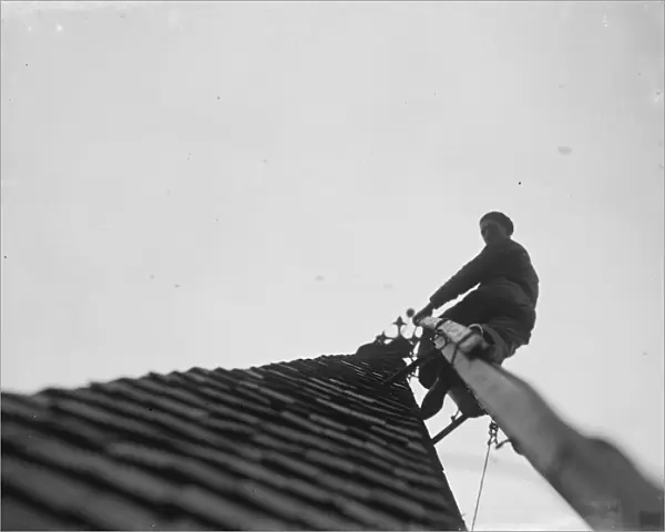 Man working up on the steeple of North Cray Church, Kent. 1936