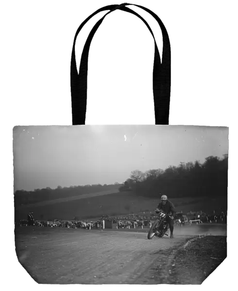 Motor cycling races at Brands Hatch on Easter Sunday. W C Lock on a scramblers take