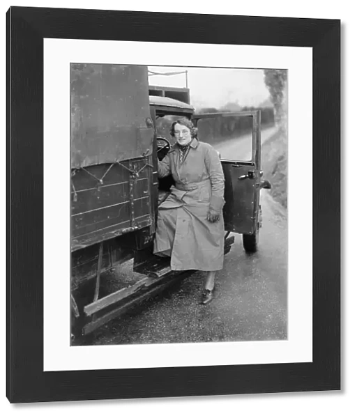Mrs E Butcher climbs into ans Butcher Carrier Bedford lorry from Wrotham, Kent