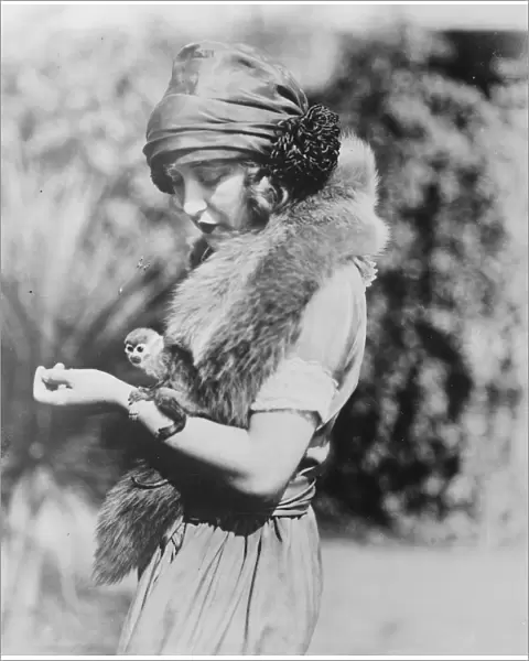 Smallest monkey in captivity. Miss Ruth Clifford, who bears a marked resemblance