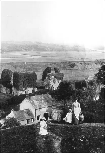 A mother and her girls climb the steep hill at the back of their garden to fetch water