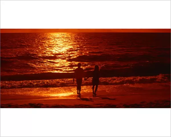 Couple on a beach in Barbados, sunset