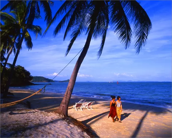 Two girls walking on a beach at Phuket, Cape Phanwa, Thailand