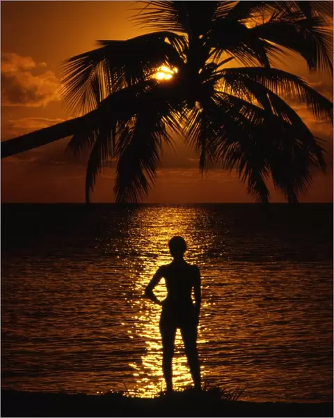 Girl on beach [Antigua] at sunset. West Indies