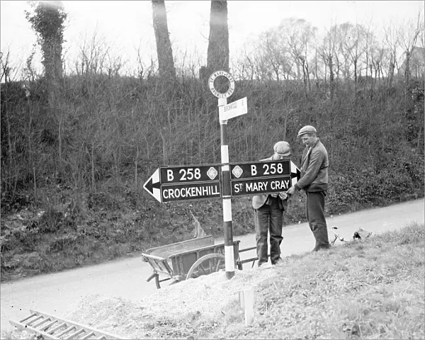 Workmen putting up an RAC secondary road sign on the B258. 1938