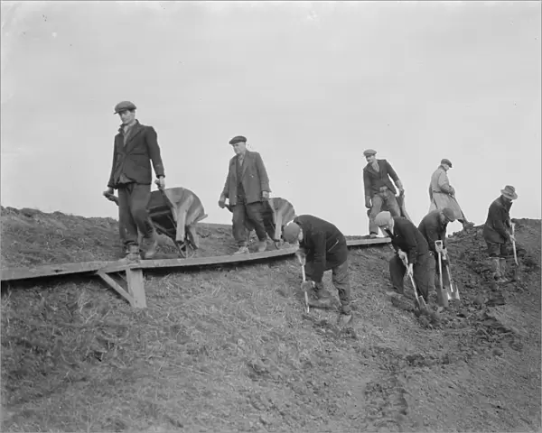 Workers increasing the river defences and doing repairs on the river wall and embankment