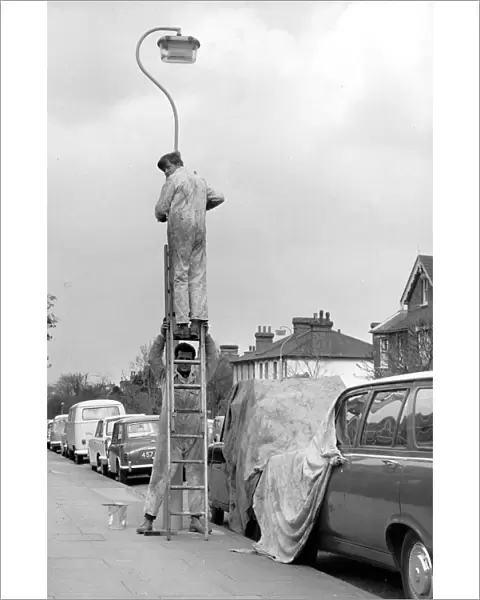 Courtesy Covers For Kerbside Cars. Workmen in a Sidcup Street in Kent. Painters carefully