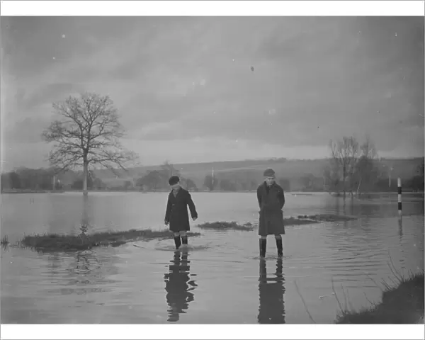 Two boys paddle through the floods in Yalding, Kent. 1936