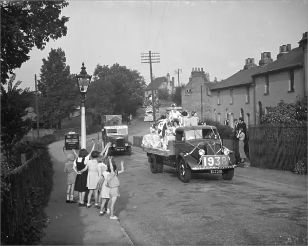 The Dartford Carnival Queen with her attendees parade on a lorry wave to the crowd