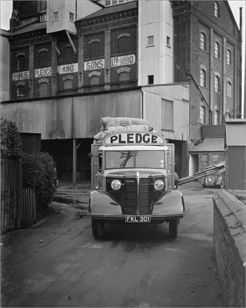 A loaded Bedford truck belonging to Pledge & Son Ltd, the milling company, pulls