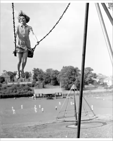 Girl on a swing in the park. 1939