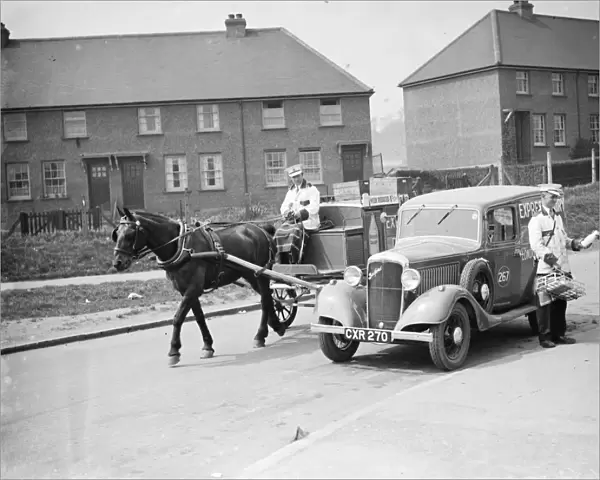 A Express Dairy Delivery horse and cart overtakes an Express Dairy Delivery Bedford van