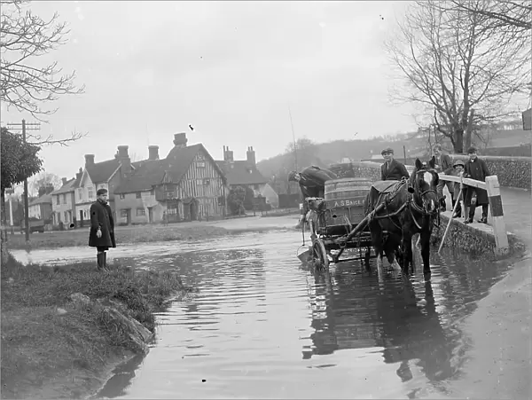 A horse and cart wades throug the ford at Eynsford in Kent watched by schoolboys