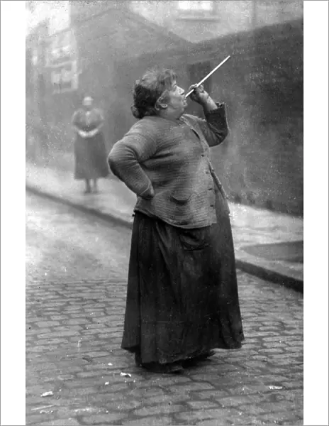 Mrs. Smith wakens the dockers of Limehouse, London, with her peashooter in 1927 TopFoto