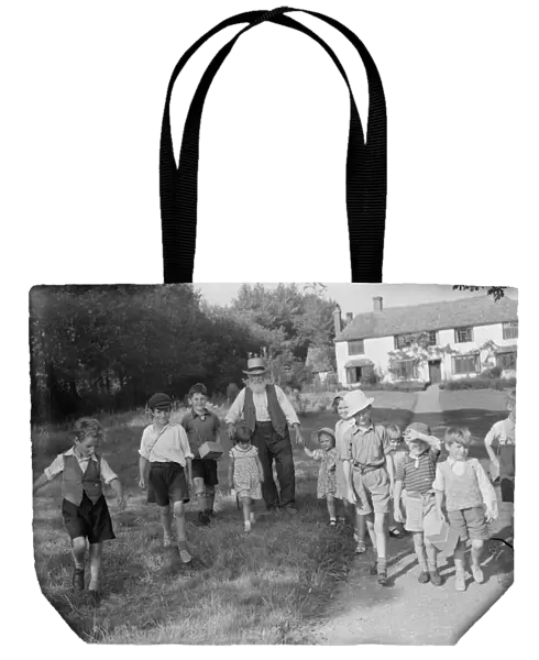 Evacuated children in Wye, Kent, walking down a country road. 1939  /  40