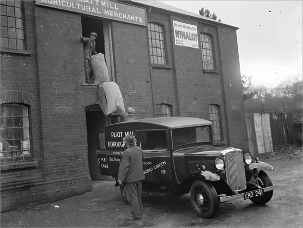 Workmen loading up a delivery van from Platt Mill, Borough Green, Kent with sacks
