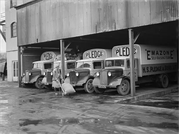 Bedford trucks belonging to Pledge & Son Ltd, the milling company, being loaded