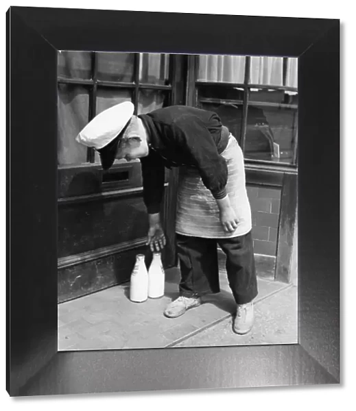 Norman Whiting, aged 11, plays at being a real milkman on Saturdays and Sundays