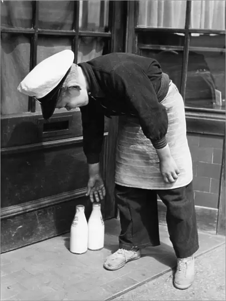 Norman Whiting, aged 11, plays at being a real milkman on Saturdays and Sundays