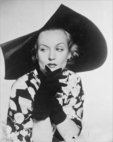 Scalloped Millinery. Carole Lombard, the Hollywood film actress, wearing a new