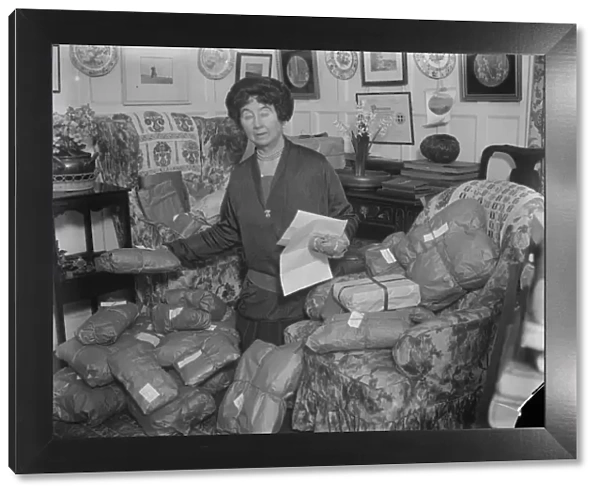 The Prime Ministers christmas gifts. Mrs Stanley Baldwin checking the christmas