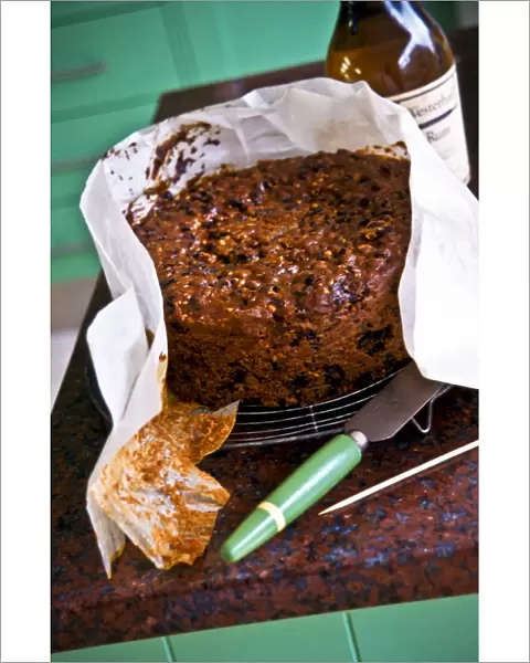 Homemade Christmas cake, being unwrapped from its greaseproof paper. credit: Marie-Louise