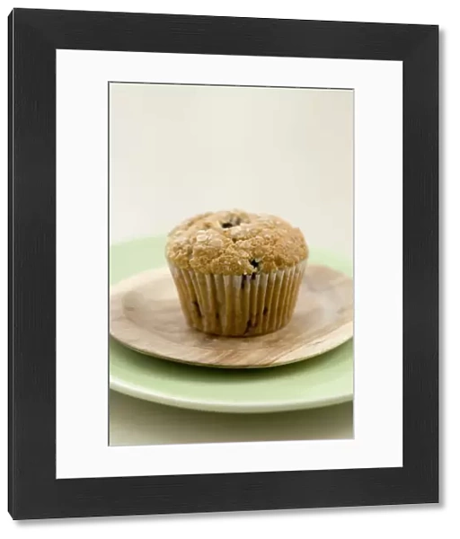 Healthy bran and raisin muffin on small wooden plate on green platter credit: Marie-Louise