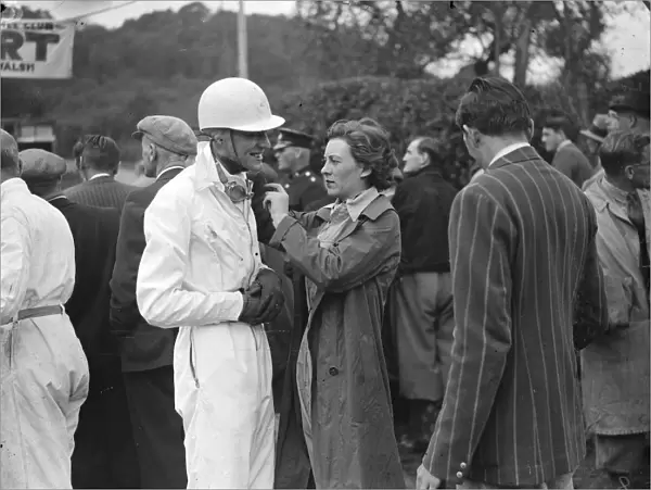 Miss Doreen Evans assists her brother K D Evans who drove an MG with her helmet before the climb