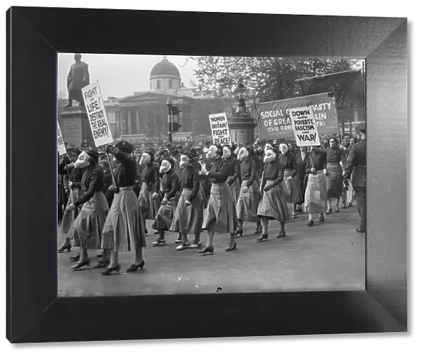 Masked women lead demonstrators in Trafalgar Square peace meeting. Led by women
