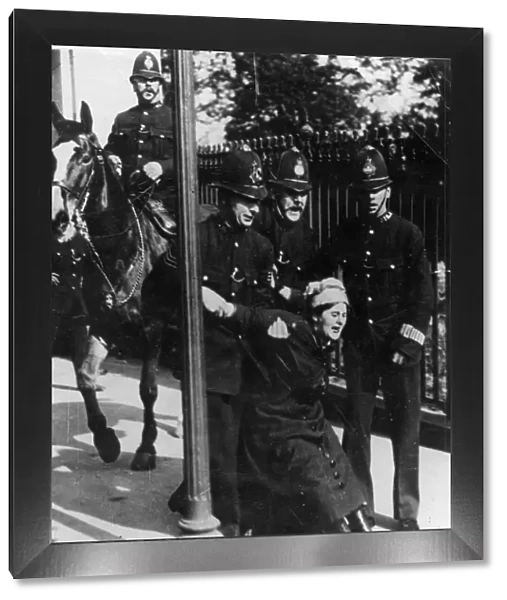 Political - four policemen, one mounted, arrest a suffragette