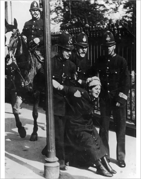 Political - four policemen, one mounted, arrest a suffragette