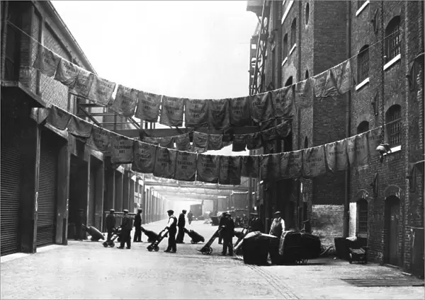 Sugar bags hanging out to dry, North Quay, West India Docks, 1900