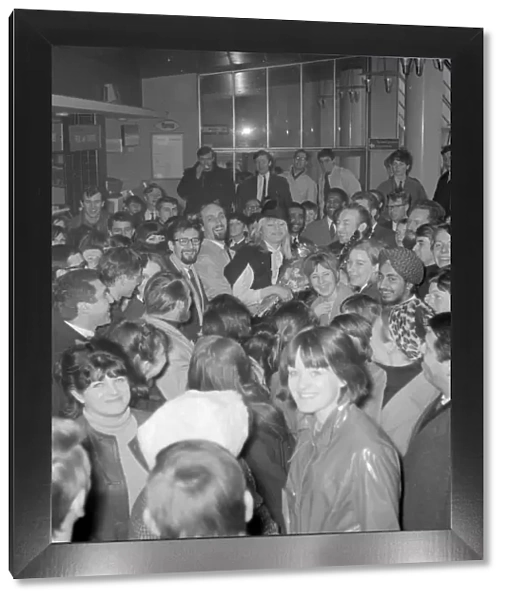 London : Fans surround folk singers Peter ( with glasses ), Paul and Mary as they