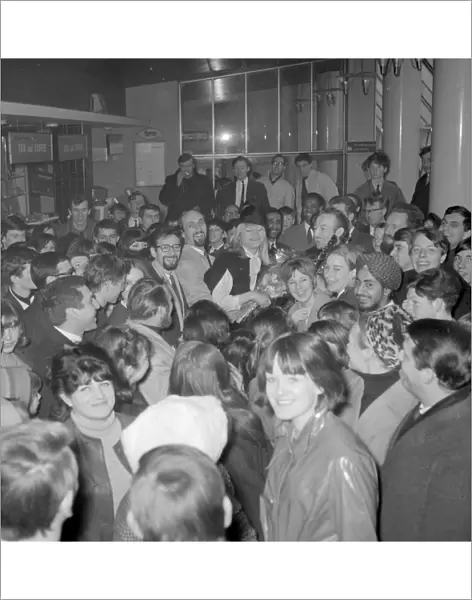 London : Fans surround folk singers Peter ( with glasses ), Paul and Mary as they