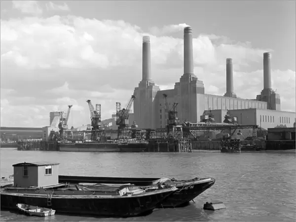 A ship unloading at the pier at Battersea Power Station, seen from across the Thames
