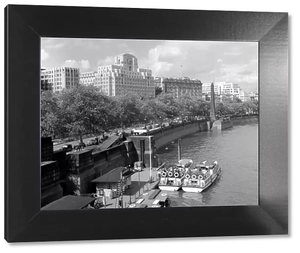 Thames river boats moored on the Victoria Embankment near to Cleopatras Needle with