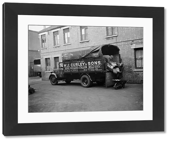 Men unloading bones and animal waste from a WJ Curleys lorry at Stratford, East London
