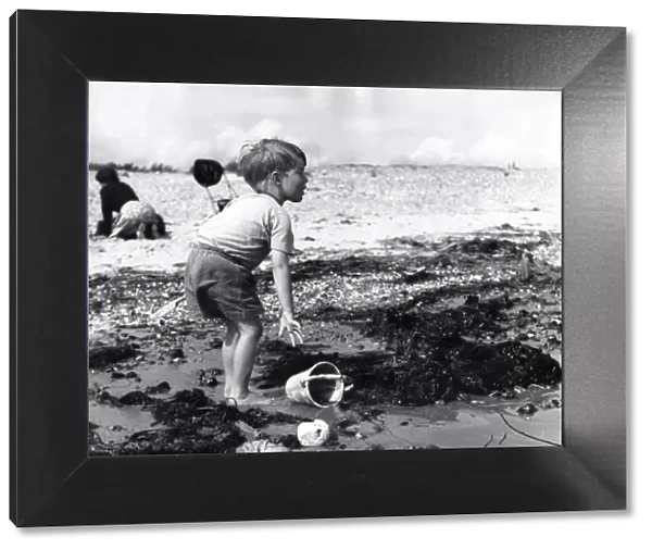 Small boy playing on the beach at Elmer Sands, Sussex, 1950 s