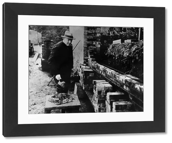 Winston Churchill building a wall at his house Chartwell near Westerham Kent. At