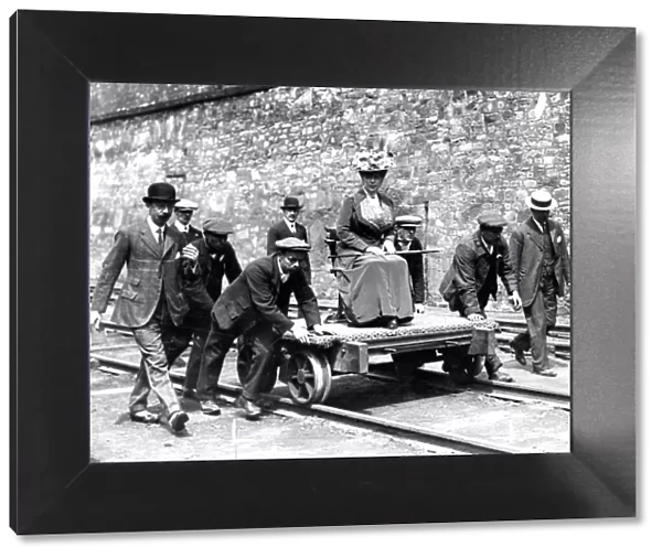 Queen Mary pictured being pushed on a coal trolley after a tour of the coal mine
