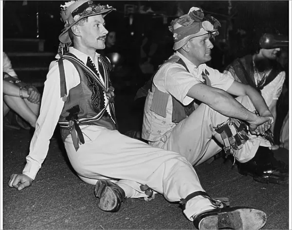 Folk Dance Festival. Lads from the country take a breather: their costumes are adorned
