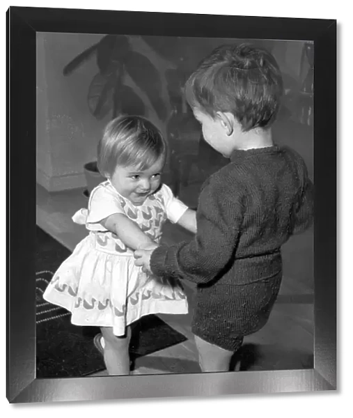 Boy and girl toddlers playing together dancing partners dance  /  dancing  /  party season